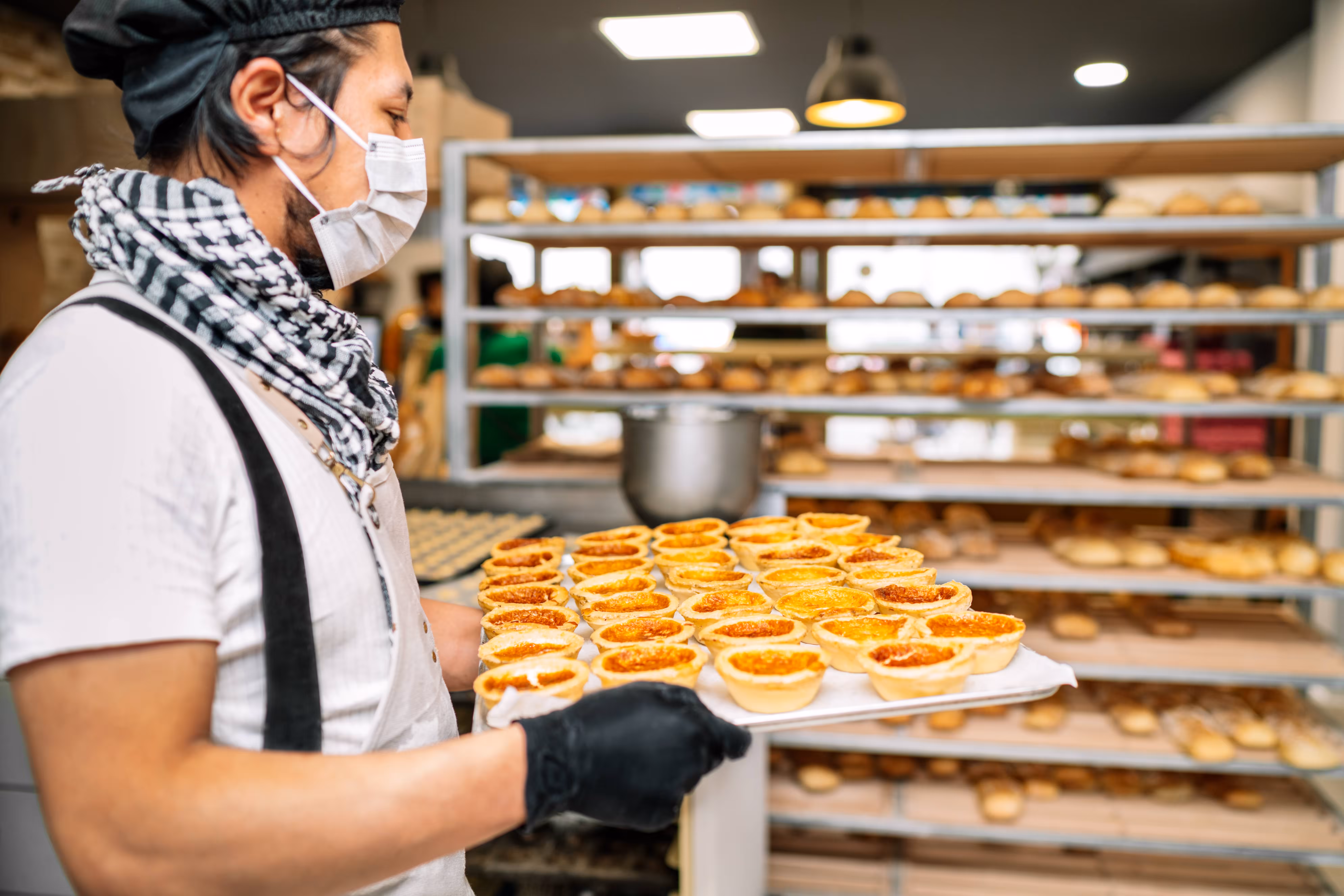 the-baker-is-holding-a-tray-of-rice-cake-fresh-lea-2024-06-06-19-34-44-utc-min